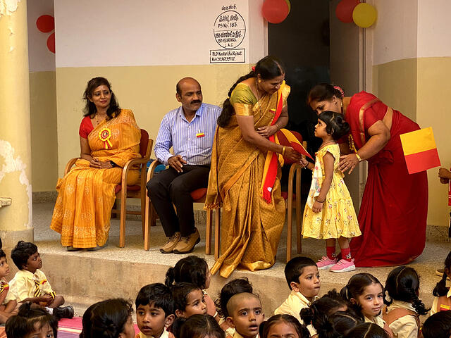 Child giving kannada flag