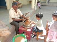 Nursery child doing diya