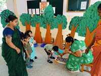 Nursery A children sowing the seeds